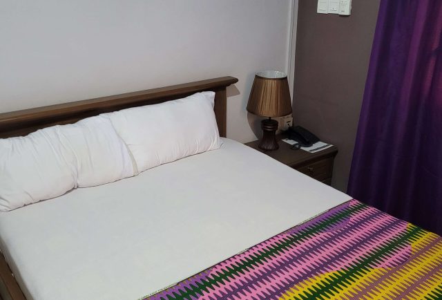 room with red cover cloth bed sheet